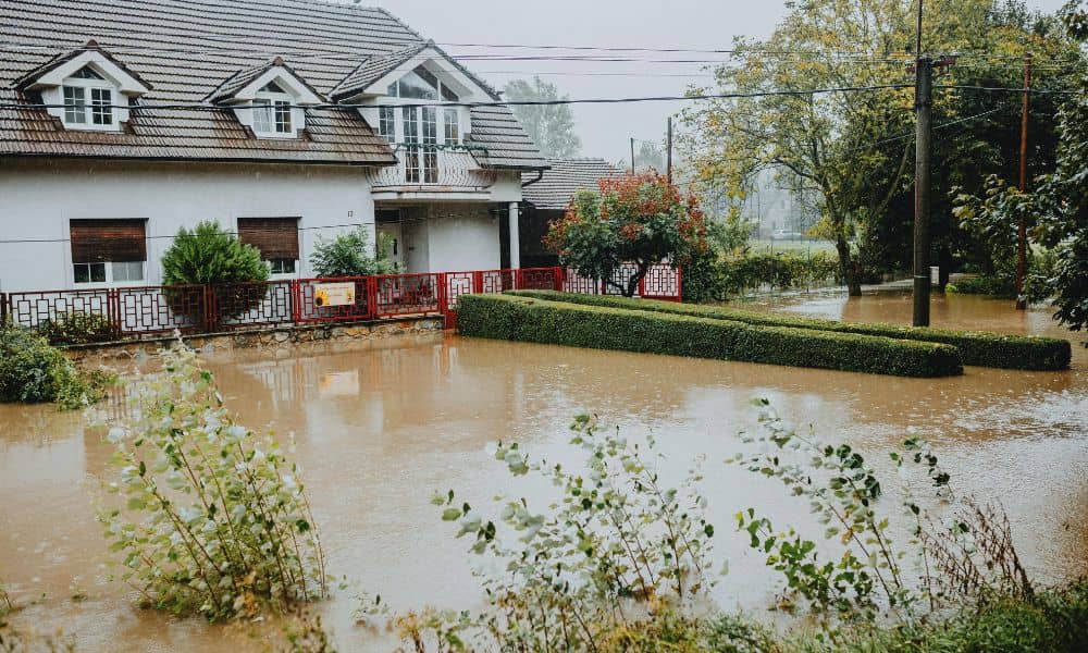 Flooded residential property - ALTA SURVEY Miami Flooded suburban home surrounded by standing water after heavy rain, showing how floods can affect property boundaries