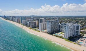 Coastal aerial view updated mapping - ALTA SURVEY Miami Aerial view of coastal buildings and shoreline where new mapping rules make drone land surveying important for planning and development
