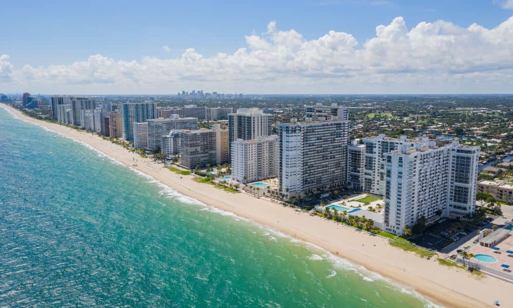 Aerial view of coastal buildings and shoreline where new mapping rules make drone land surveying important for planning and development
