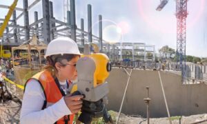 Topo survey commercial development miami - ALTA SURVEY Miami Surveyor performing a topo survey with total station equipment at a commercial construction site in Miami.
