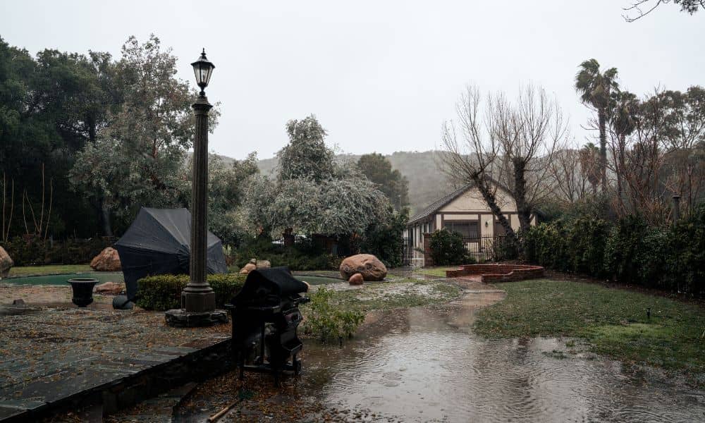 Flooded residential yard after heavy rain showing why a property survey is needed to spot drainage issues