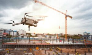 altitude drone over construction - ALTA SURVEY Miami Drone surveying a busy construction site with workers and cranes in the background, illustrating modern land surveying technology in construction.