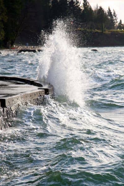 Seawater crashing against a seawall, showing the flood and elevation risks that an ALTA Land Title Survey helps identify for waterfront properties
