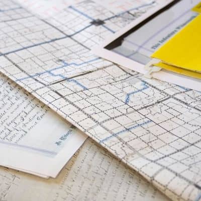 Property records and survey plats reviewed during a boundary survey to verify lot lines and legal property descriptions