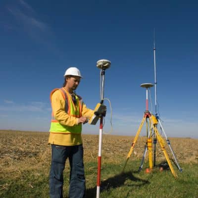 Field surveyor gps boundary measurement - ALTA SURVEY Miami Surveyor performing measurements during a residential land survey