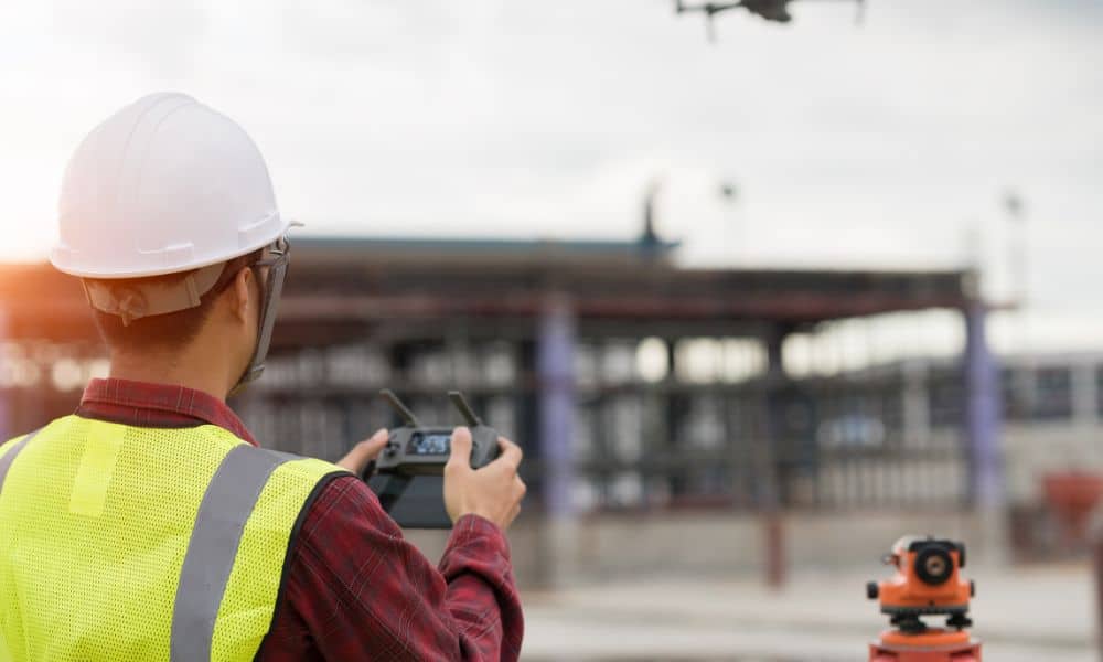 Drone land survey construction site - ALTA SURVEY Miami Surveyor flying a drone to map land at a construction site where surveying companies measure property details before development begins